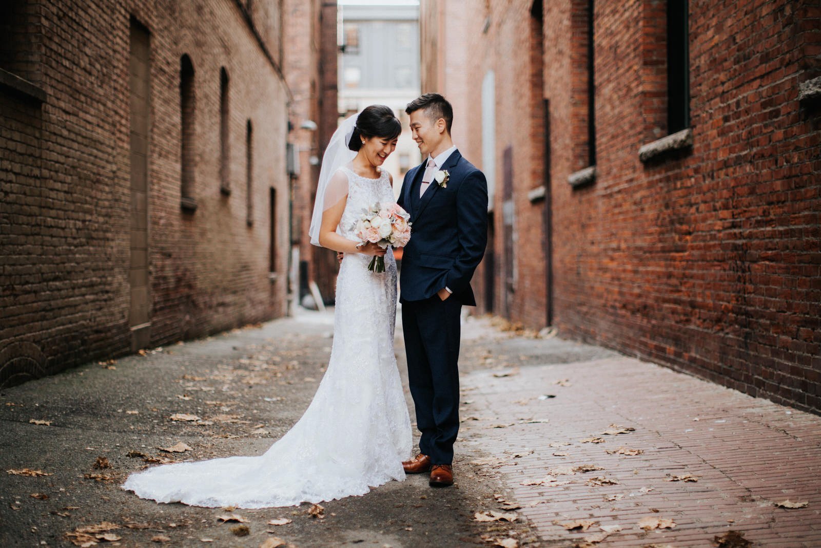 The couple poses in an alleyway in pioneer square during wedding photos at hotel 1000 
